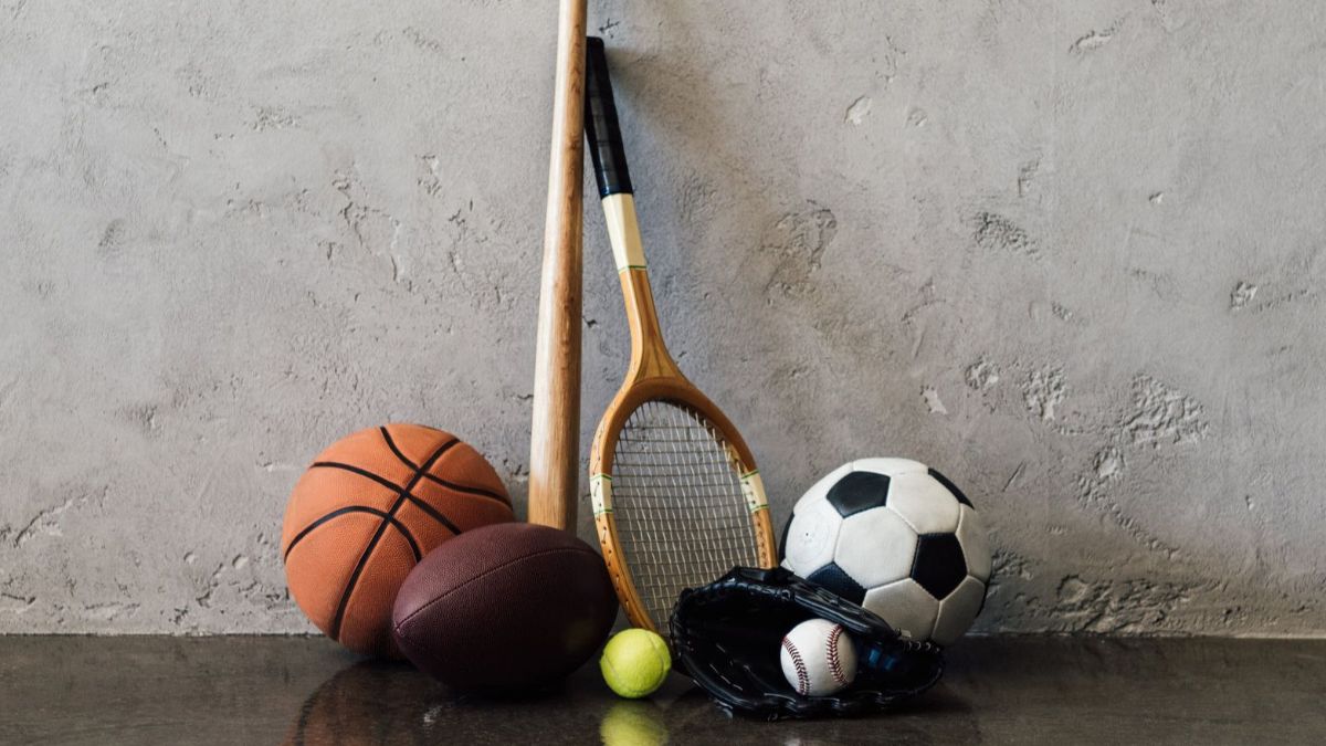 Variety of sport accessories next to a concrete wall