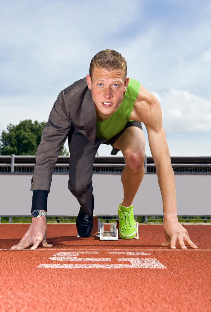 Conceptual image of an athlete (sprinter) ready to start a business career. Performane in business is top sport